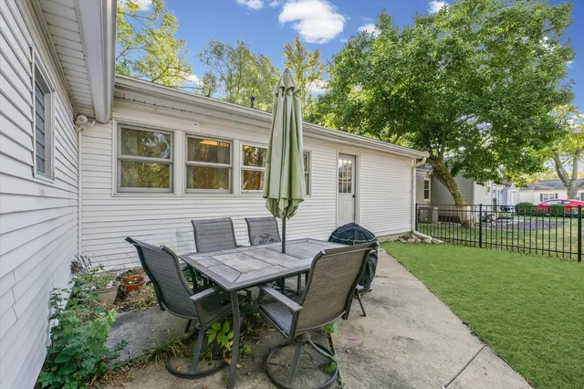 a view of a house with backyard and sitting area