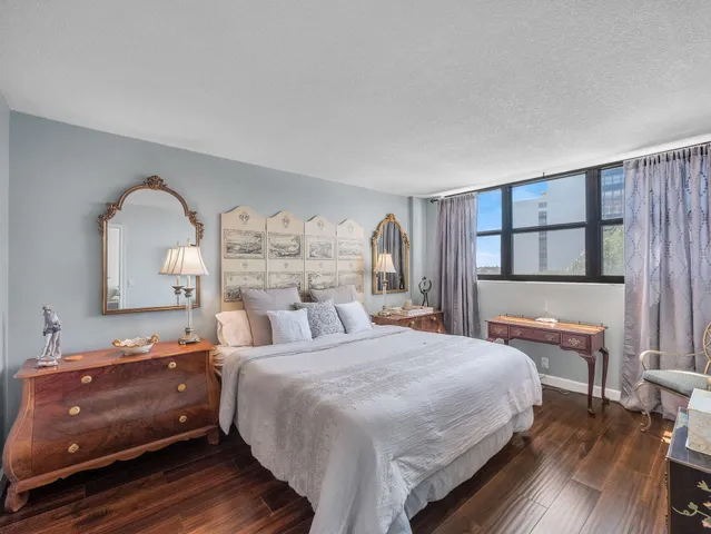 a bathroom with a toilet a sink a tub and a mirror