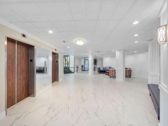 a room with pool table and windows
