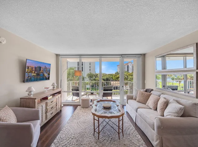 a living room with furniture and a floor to ceiling window
