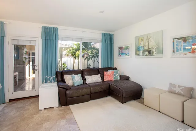 a kitchen with stainless steel appliances a sink a refrigerator a microwave a dining table and chairs with wooden floor