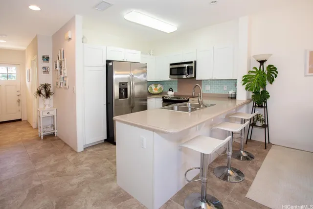 a kitchen with stainless steel appliances a sink a stove and microwave