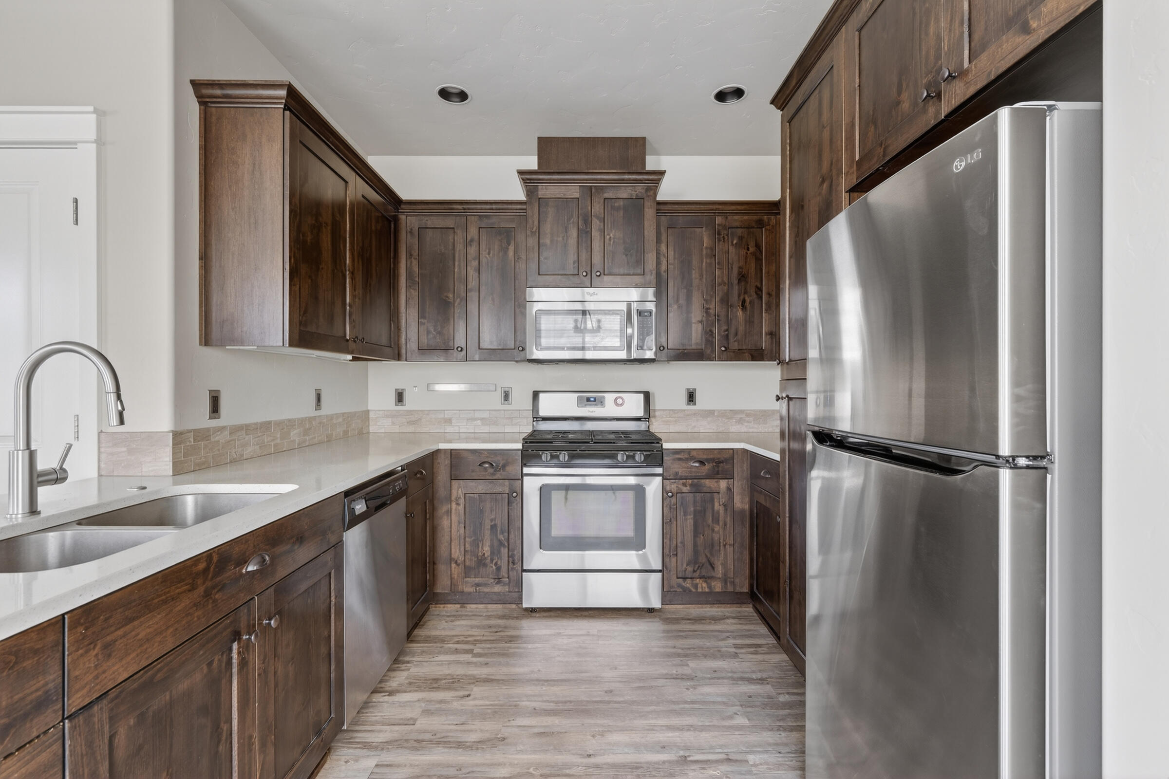 3365 Southwest 28th Street Redmond, OR 97756 - Photo 7 of 39 a kitchen with stainless steel appliances a refrigerator sink and cabinets