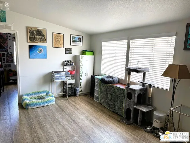 a bedroom with furniture and a flat screen tv