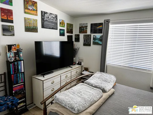 a bathroom with a granite countertop sink toilet a mirror and a shower