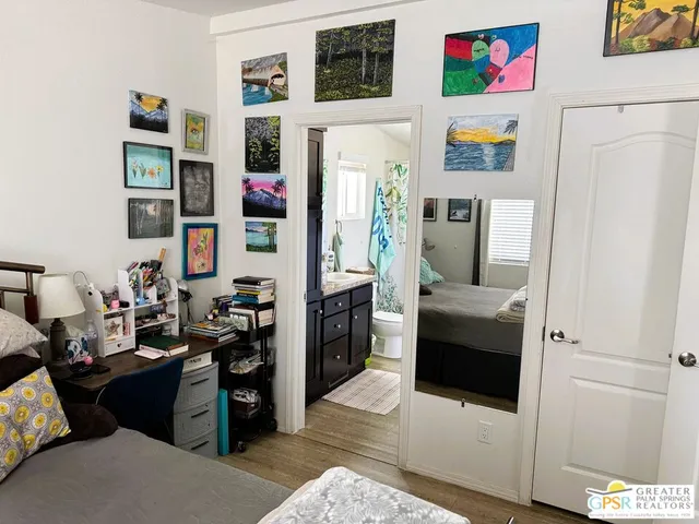 a living room with furniture a fireplace and a large window