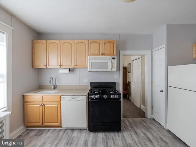 a kitchen with a refrigerator and a stove top oven