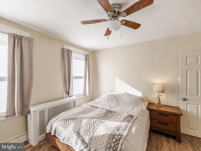 a bedroom with a bed dresser and a window