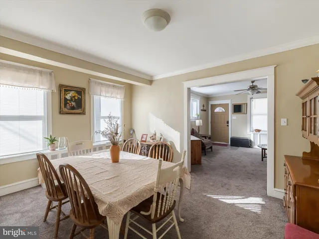 a view of a dining room with furniture and window