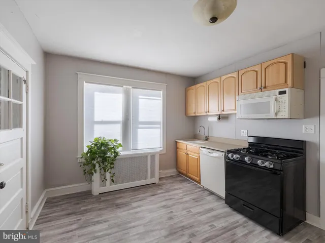 a kitchen with a stove a sink and a refrigerator