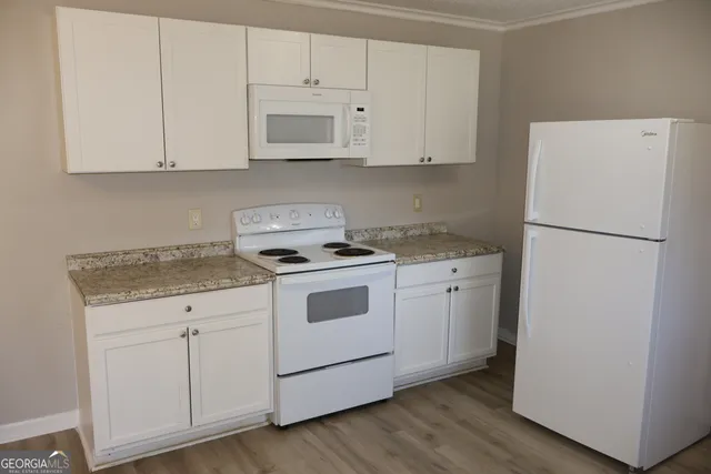 a kitchen with white cabinets stainless steel appliances and sink