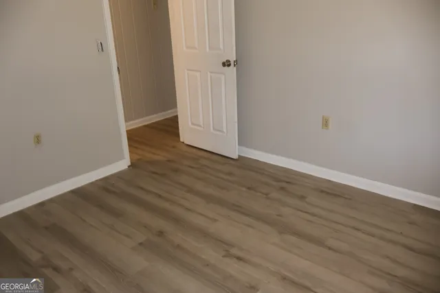 an empty room with wooden floor