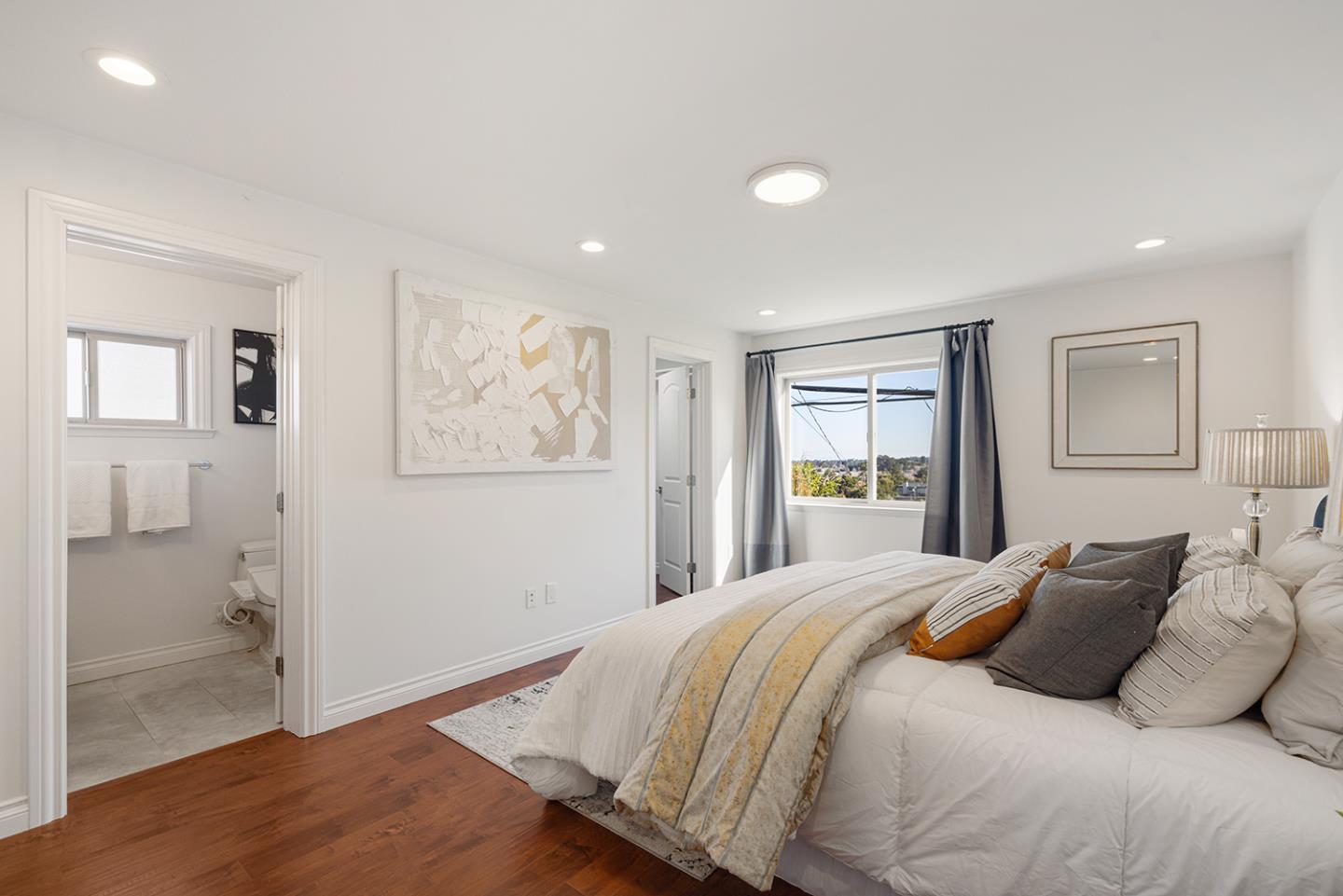 943 Hillcrest Boulevard Millbrae, CA 94030 - Photo 29 of 51 a bedroom with a large bed and a painting on the wall