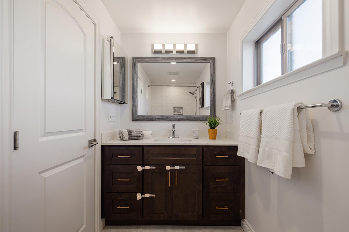 943 Hillcrest Boulevard Millbrae, CA 94030 - Photo 32 of 51 a bathroom with a sink vanity and a mirror