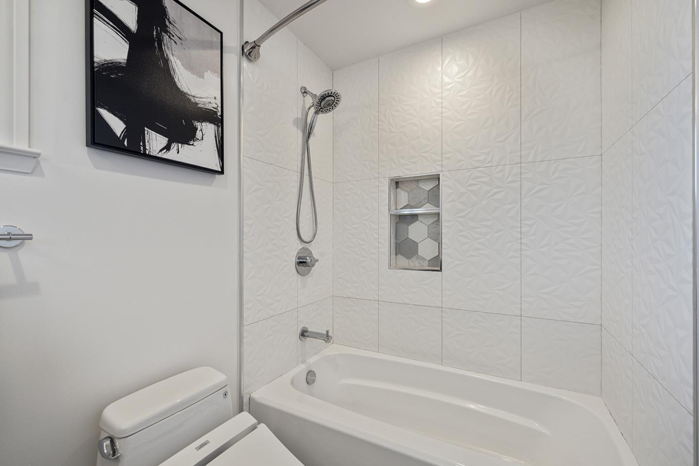 943 Hillcrest Boulevard Millbrae, CA 94030 - Photo 33 of 51 a white bath tub sitting next to a white toilet and vanity