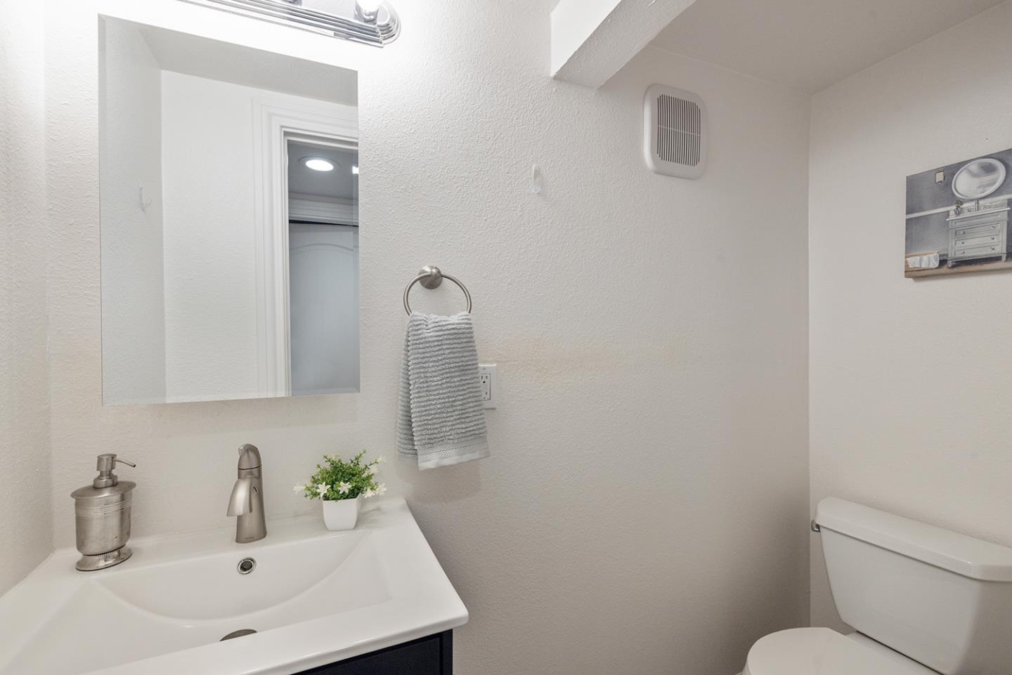 943 Hillcrest Boulevard Millbrae, CA 94030 - Photo 43 of 51 a bathroom with a sink toilet and a mirror