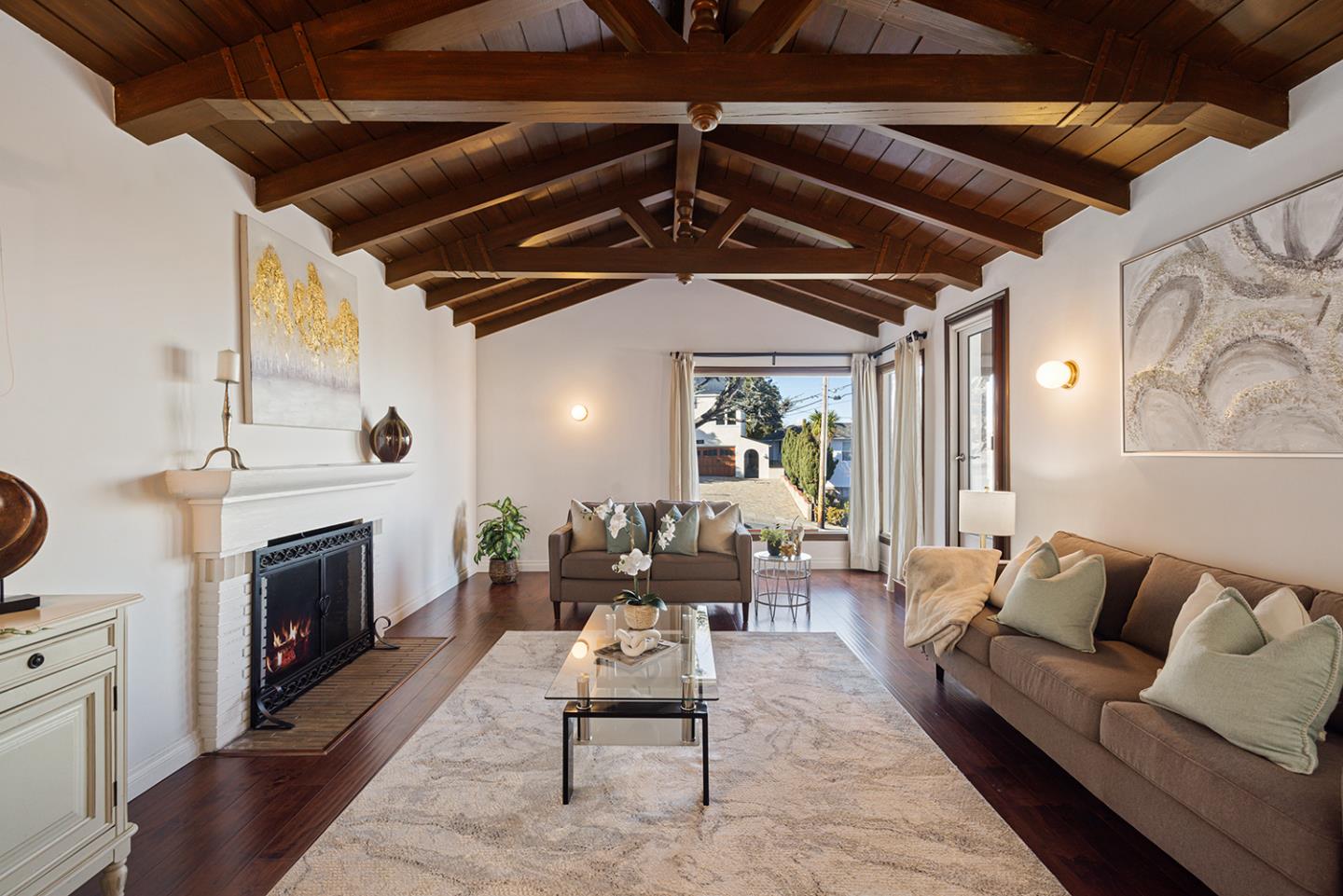 943 Hillcrest Boulevard Millbrae, CA 94030 - Photo 8 of 51 a living room with furniture and a fireplace