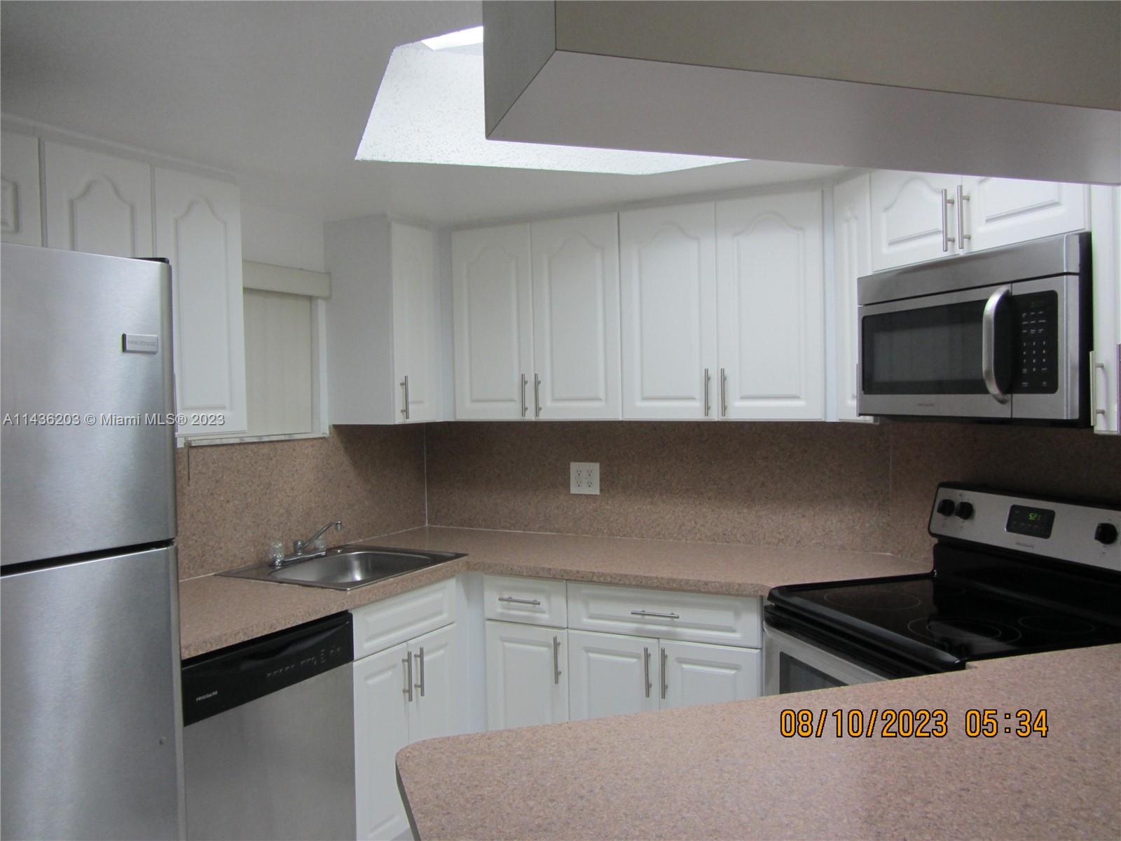 Doral Doral, FL 33166 - Photo 16 of 28 a kitchen with stainless steel appliances a sink a stove a microwave and cabinets