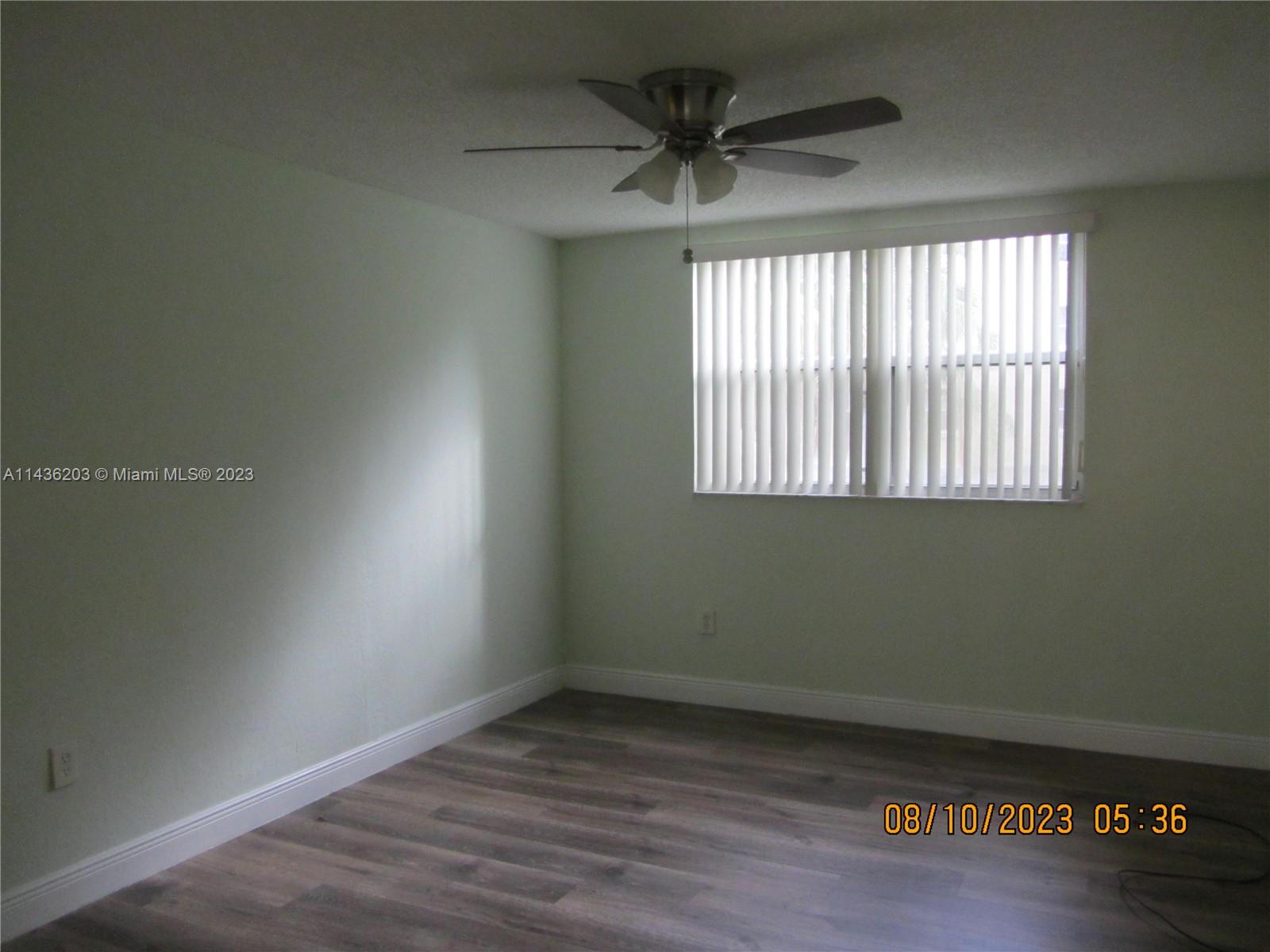 Doral Doral, FL 33166 - Photo 23 of 28 an empty room with wooden floor and windows