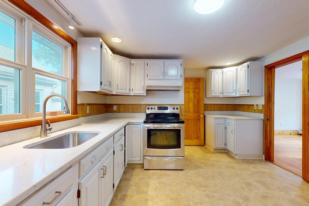 58 Teel Street, Unit 58 Arlington, MA 02474 - Photo 12 of 22 a kitchen with a sink stove and cabinets