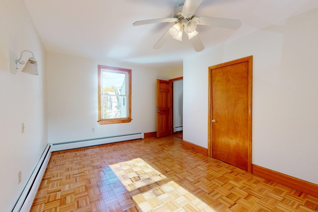 58 Teel Street, Unit 58 Arlington, MA 02474 - Photo 15 of 22 a view of empty room with window and ceiling fan