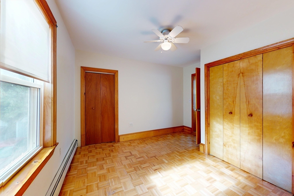 58 Teel Street, Unit 58 Arlington, MA 02474 - Photo 16 of 22 a view of a room with a chandelier fan and closet