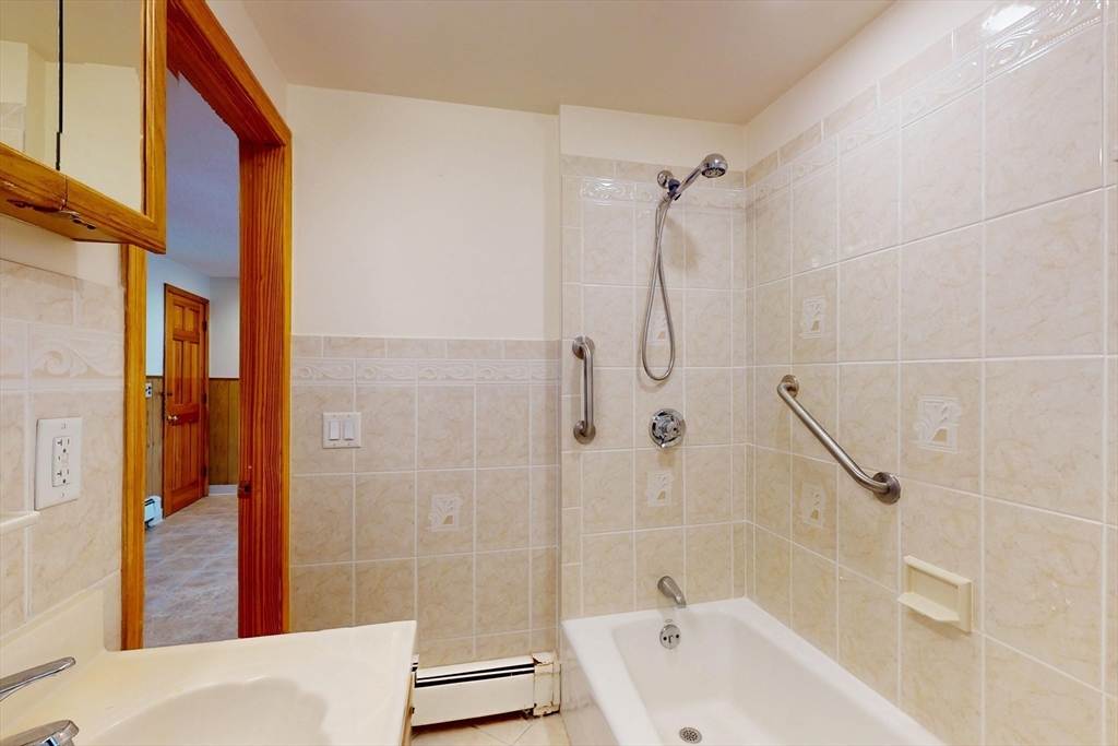 58 Teel Street, Unit 58 Arlington, MA 02474 - Photo 19 of 22 a bathroom with a shower and a bathtub