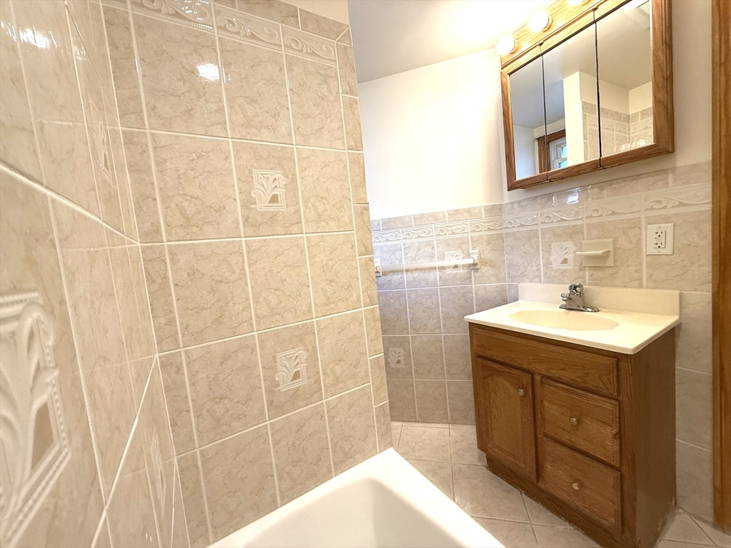 58 Teel Street, Unit 58 Arlington, MA 02474 - Photo 20 of 22 a bathroom with a sink shower and a mirror