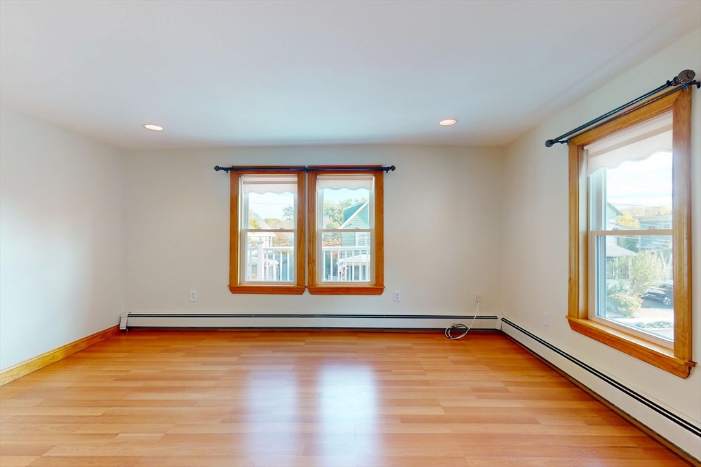 58 Teel Street, Unit 58 Arlington, MA 02474 - Photo 7 of 22 a view of an empty room with wooden floor and a window