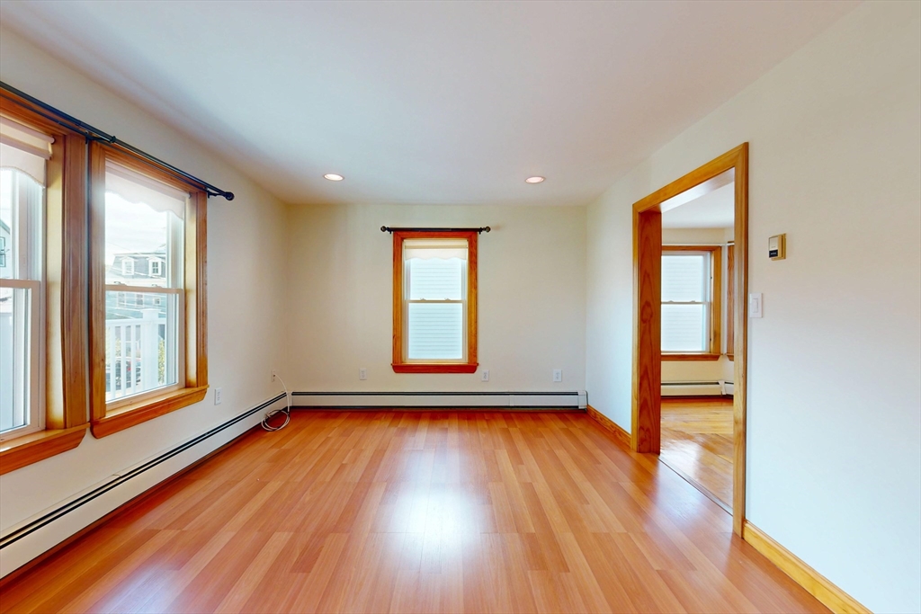 58 Teel Street, Unit 58 Arlington, MA 02474 - Photo 9 of 22 a view of an empty room with wooden floor and a window
