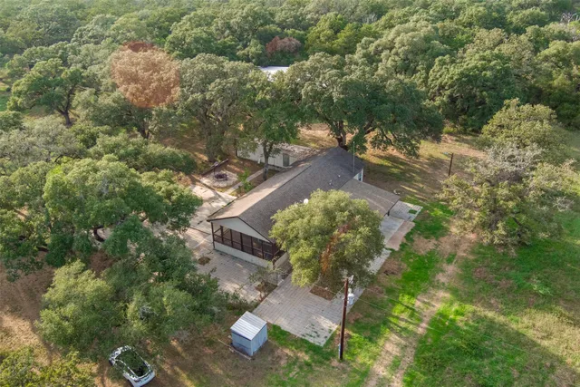 a view of a house with garden and sitting area