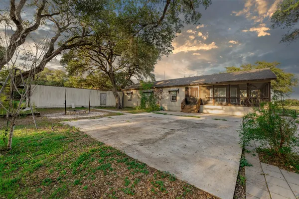 a backyard of a house with table and chairs
