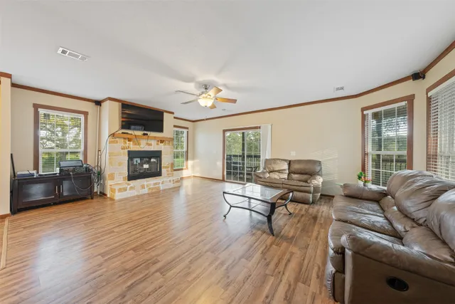 a living room with furniture a fireplace and a flat screen tv