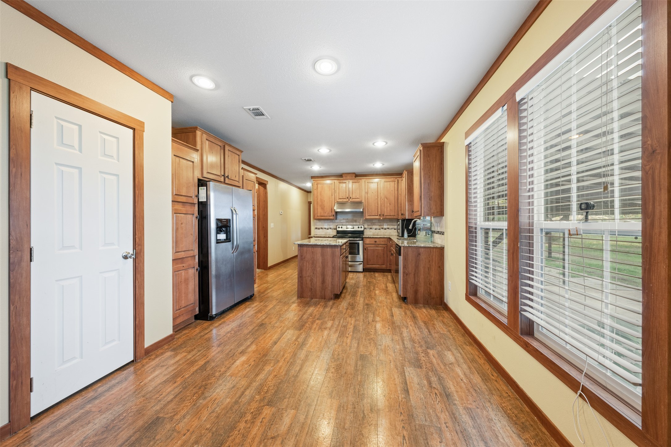 4636 Highway 71 Columbus, TX 78934 - Photo 35 of 50 a view of a kitchen with kitchen island wooden floors stainless steel appliances