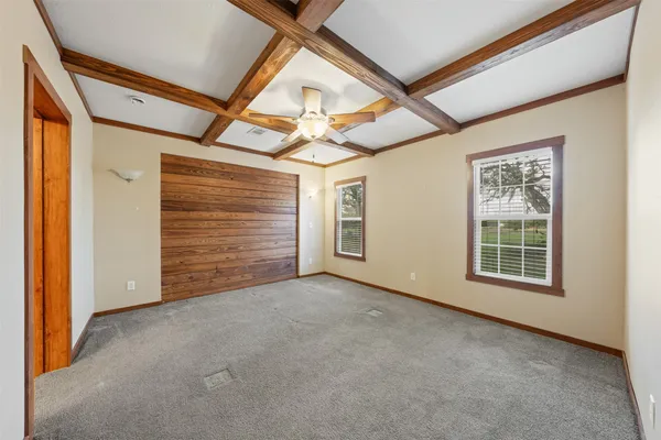 an empty room with windows and closet