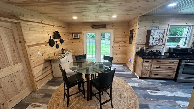 a view of a porch with a table and chairs