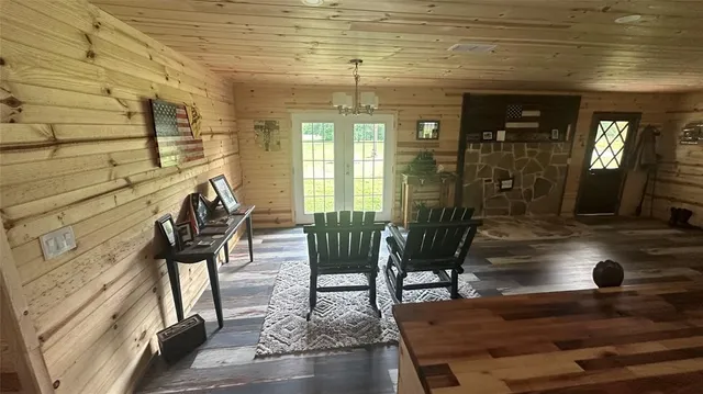 a large bedroom with wooden floor and large window