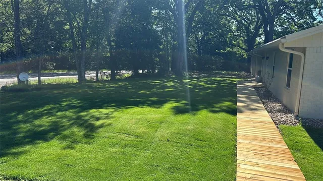 a backyard of a house with lots of green space
