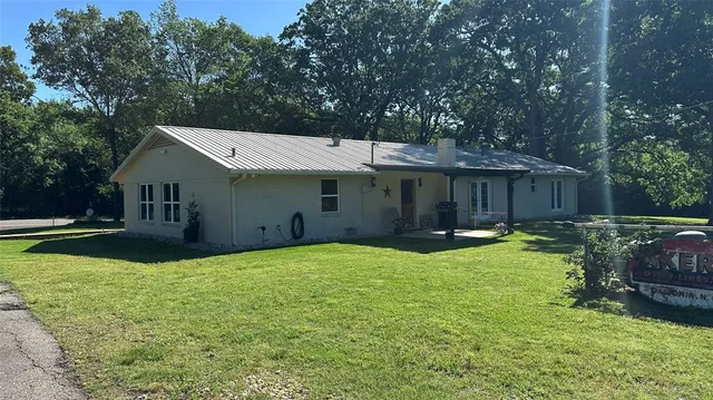 a view of house with outdoor space and swimming pool