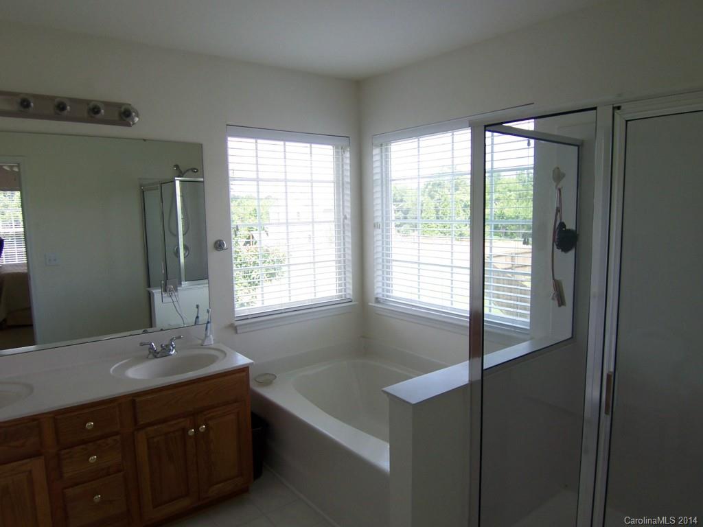 415 Lafinca Court Fort Mill, SC 29708 - Photo 12 of 17 a bathroom with a double vanity sink and a large mirror