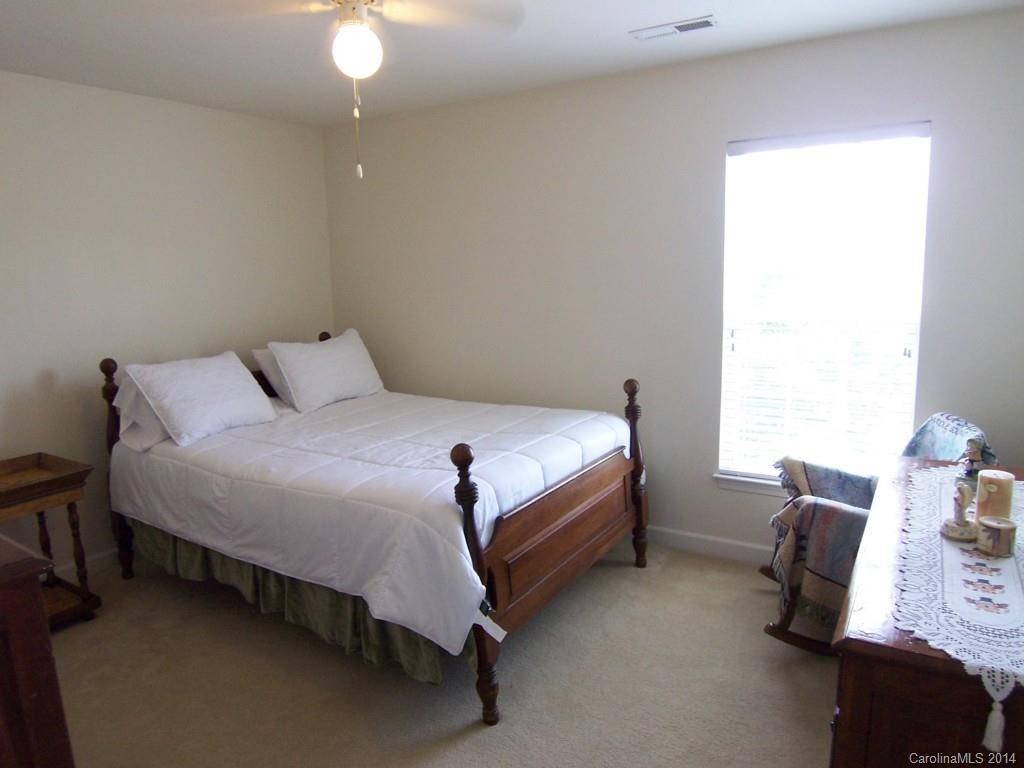 415 Lafinca Court Fort Mill, SC 29708 - Photo 13 of 17 a bedroom with a bed and a chair