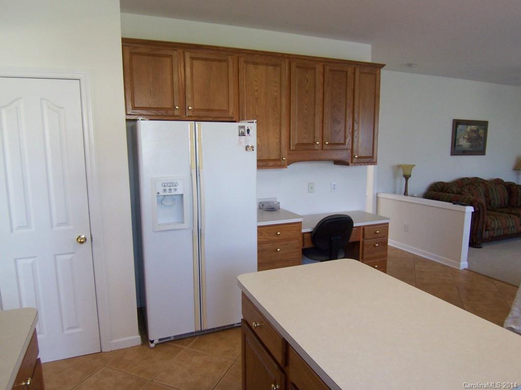 415 Lafinca Court Fort Mill, SC 29708 - Photo 9 of 17 a kitchen with a refrigerator a table and chairs