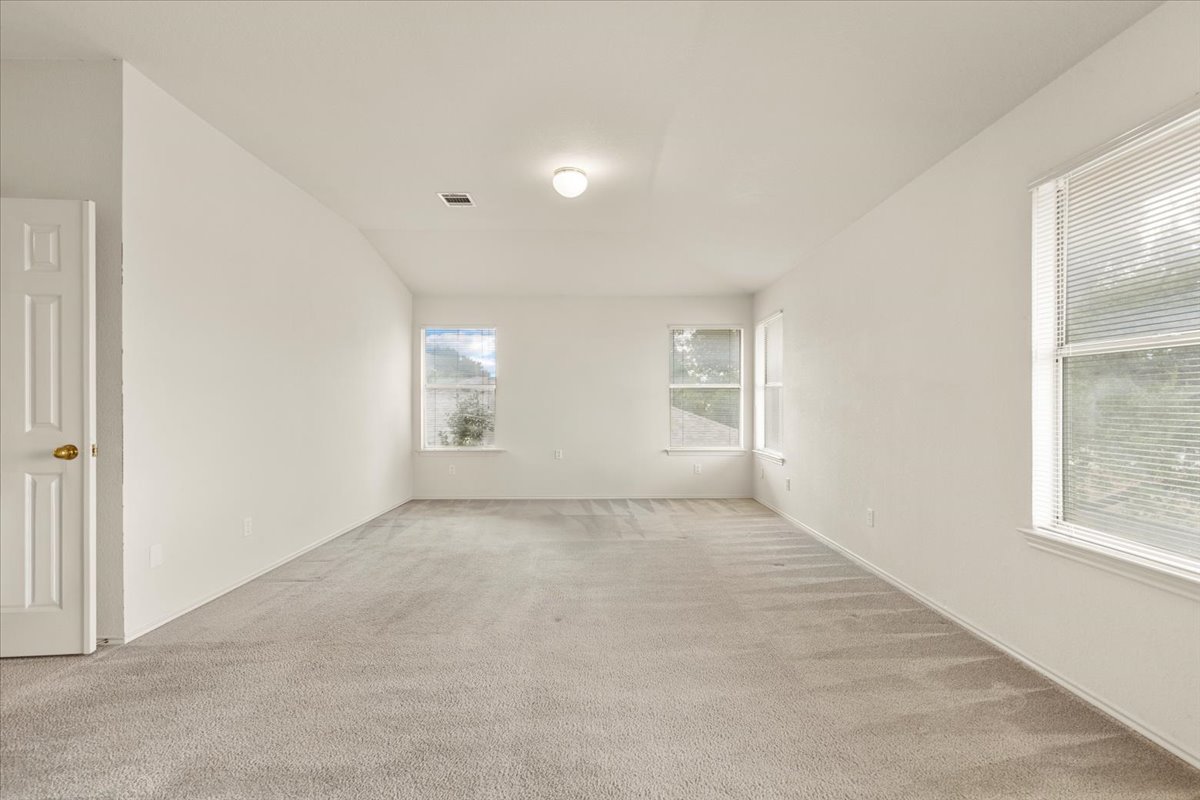 3929 Katzman Drive Austin, TX 78728 - Photo 13 of 29 Spare room featuring carpet flooring and baseboards
