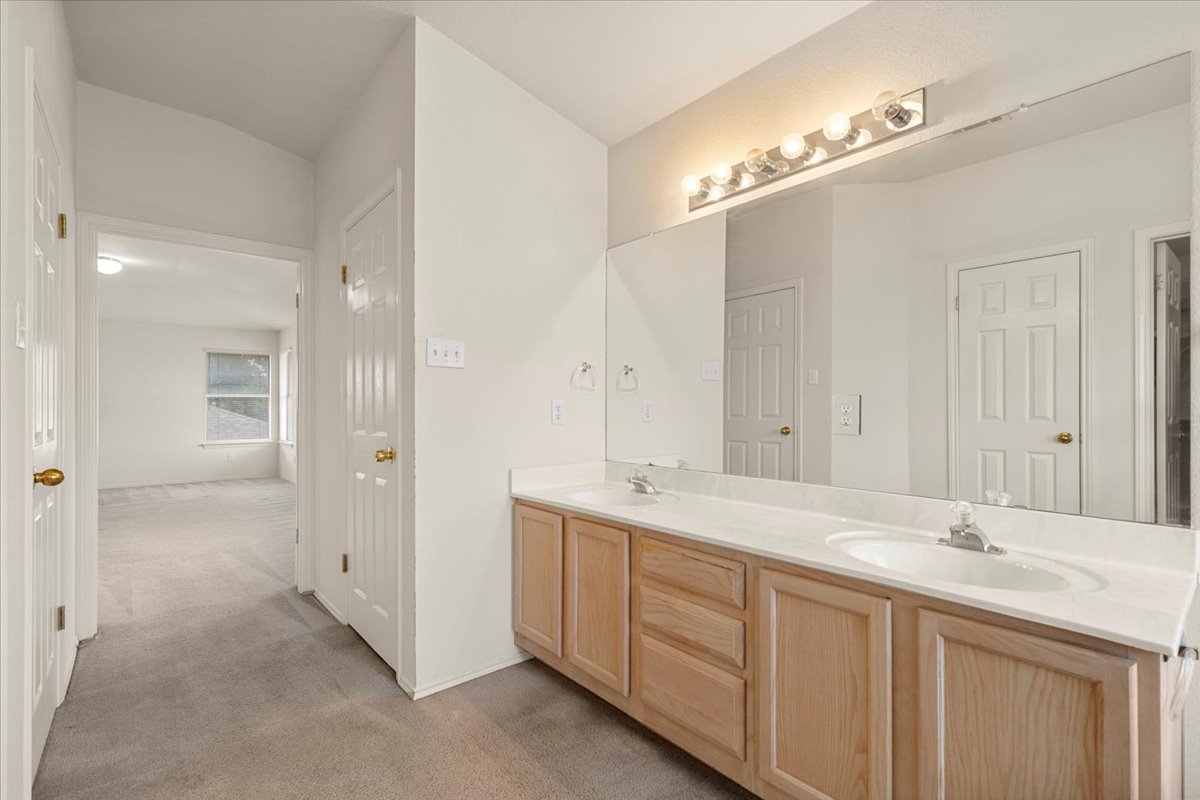 3929 Katzman Drive Austin, TX 78728 - Photo 16 of 29 Full bath with light colored carpet and double vanity