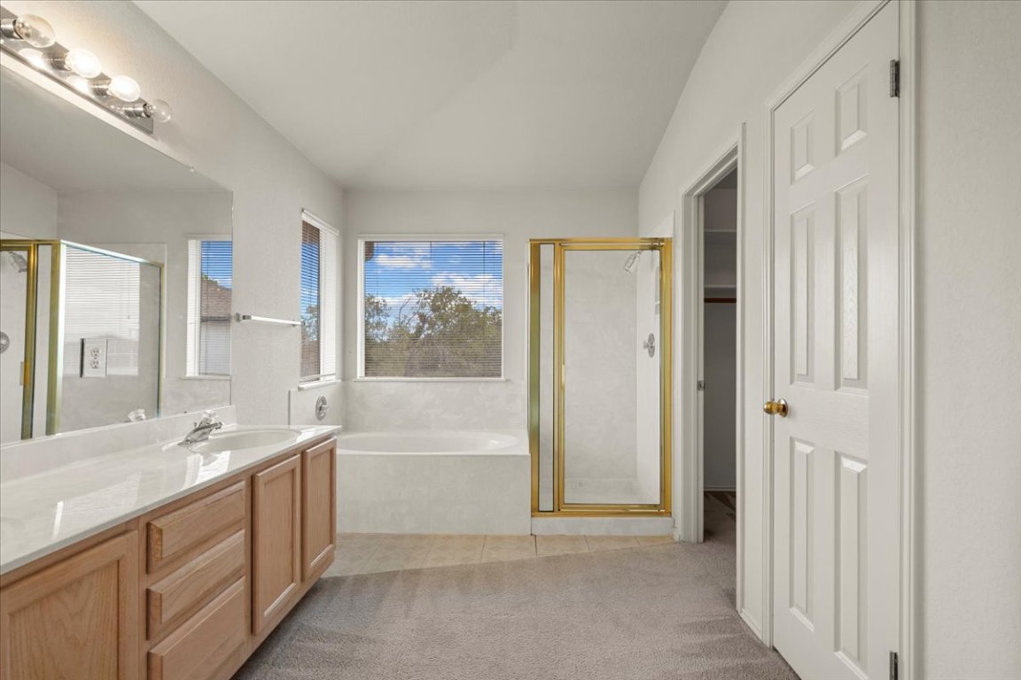 3929 Katzman Drive Austin, TX 78728 - Photo 17 of 29 a bathroom with a tub sink and mirror