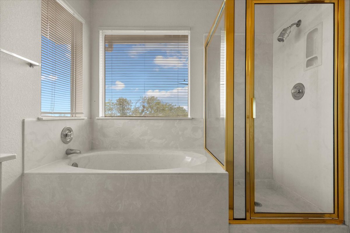 3929 Katzman Drive Austin, TX 78728 - Photo 18 of 29 Bathroom with a bath and a shower stall