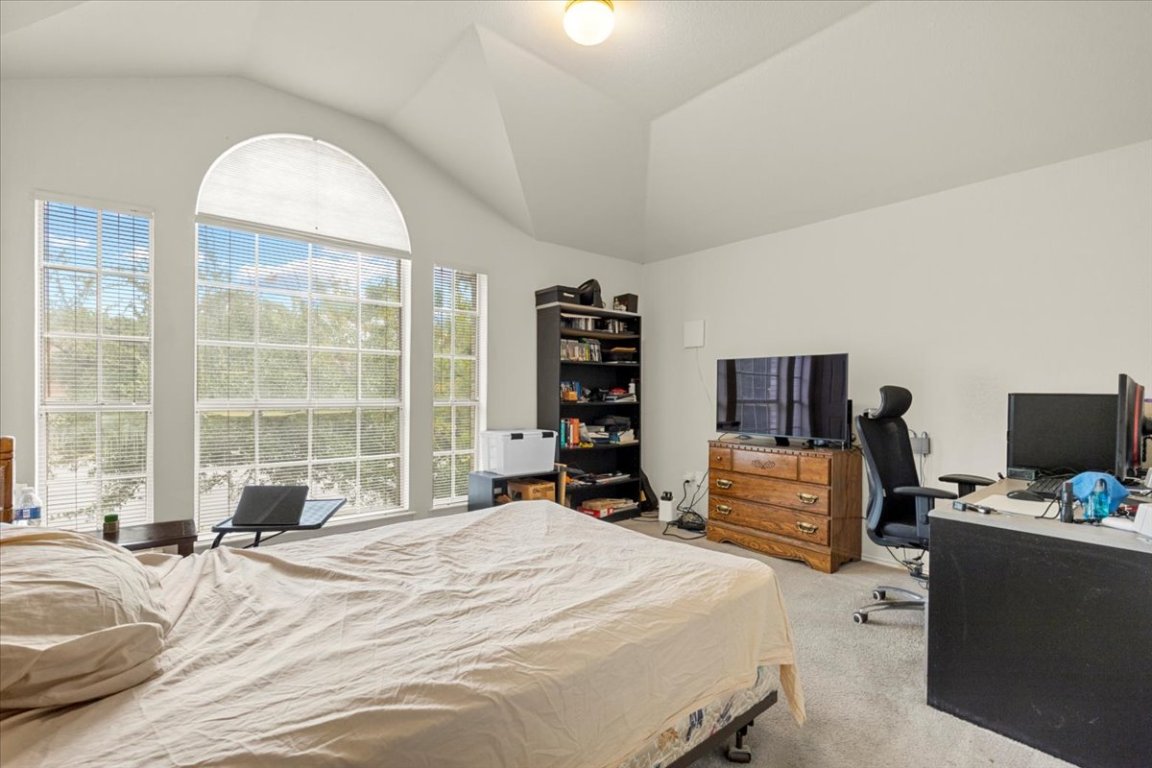 3929 Katzman Drive Austin, TX 78728 - Photo 20 of 29 a bedroom with a bed and a flat screen tv