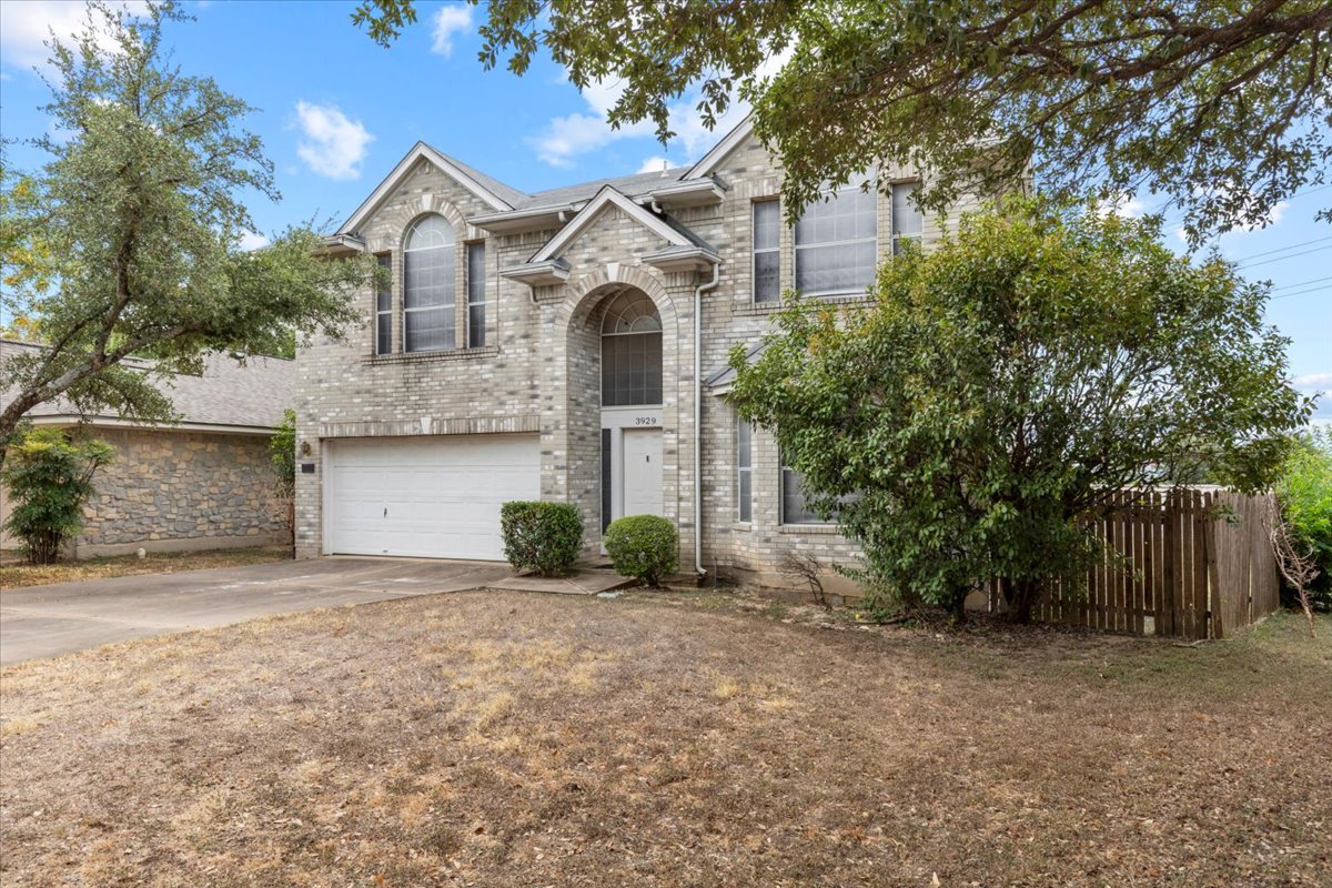 3929 Katzman Drive Austin, TX 78728 - Photo 2 of 29 Traditional-style house featuring concrete driveway, an attached garage, and brick siding