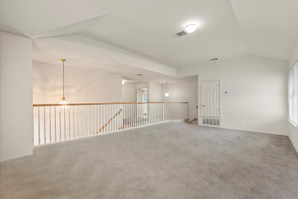 3929 Katzman Drive Austin, TX 78728 - Photo 24 of 29 Unfurnished room featuring vaulted ceiling and carpet flooring