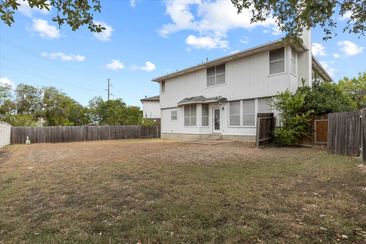 3929 Katzman Drive Austin, TX 78728 - Photo 26 of 29 Rear view of property with a fenced backyard, a chimney, and entry steps